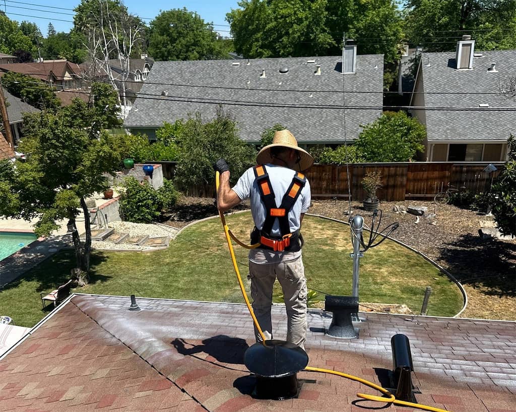 Roof Maxx technician applying Roof Maxx