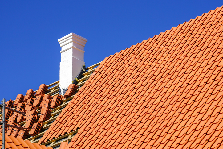 restoration of a historic wooden house, chimney repair and replacement of roof clay tiles