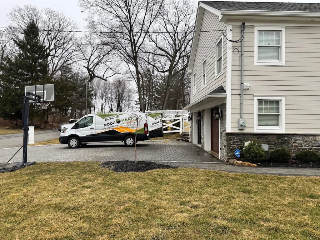 Roof Maxx of Westwood,NJ Truck in front of customer's home