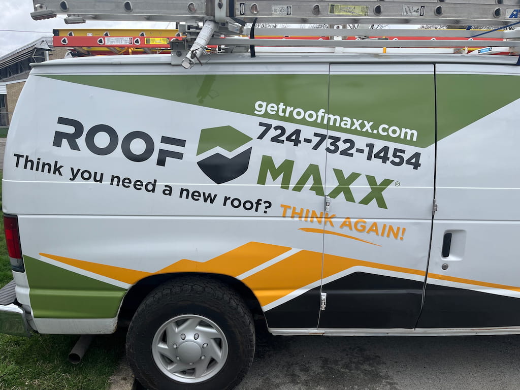 Roof Maxx Dealer truck with the phone on it.