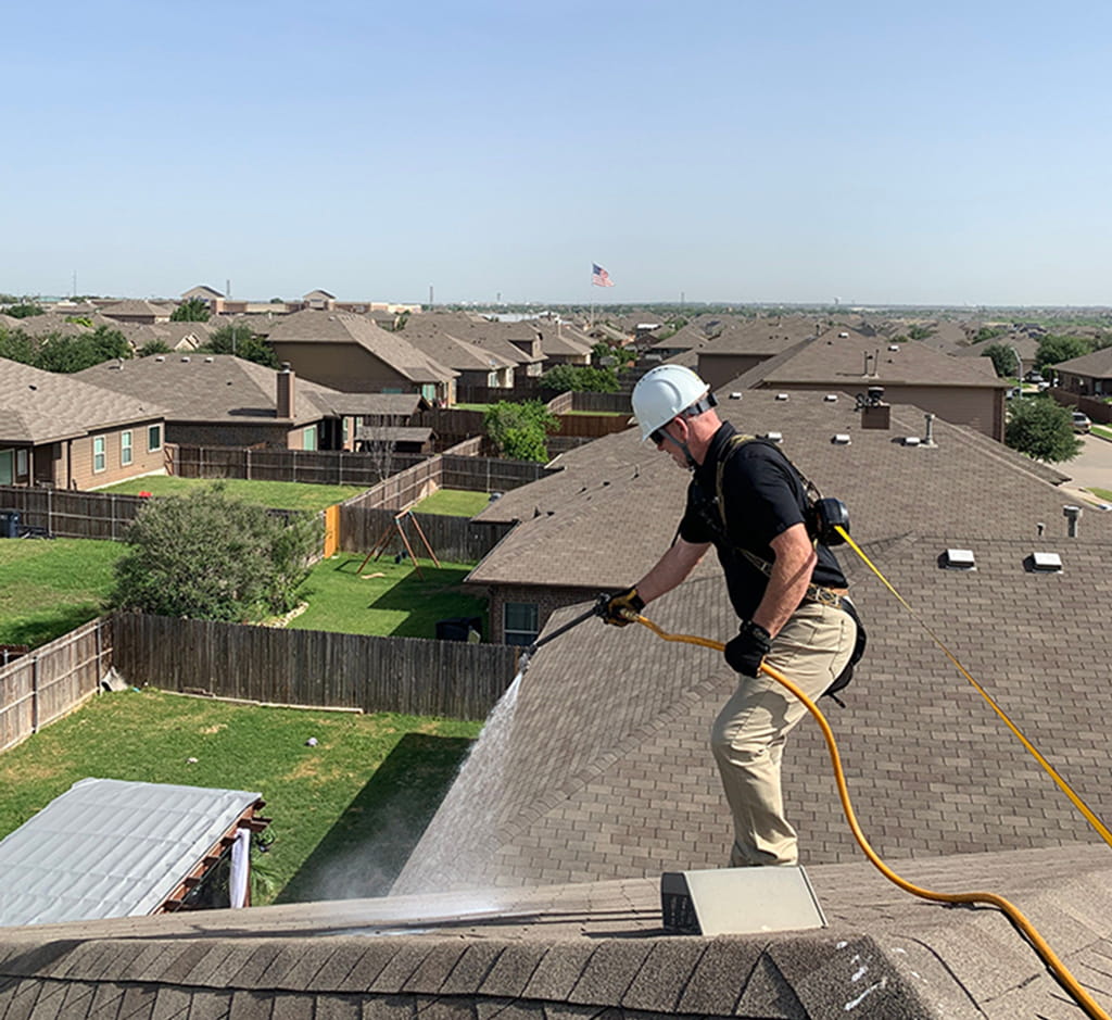 Roof Maxx of Keller-TX technician applying the roofmaxx treatment