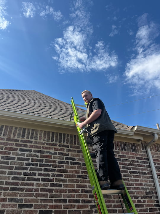 Technician of Roof Maxx of McKinney,TX climbing the ladder.