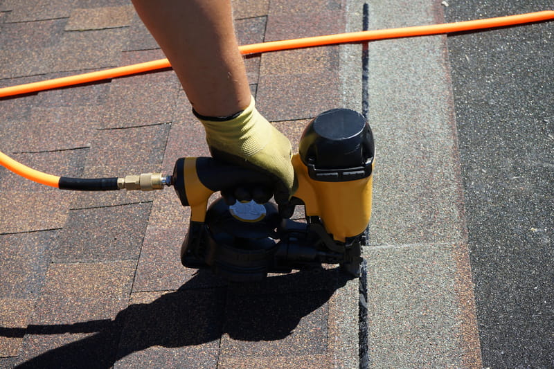 A Roof Maxx dealer repairs a customer's roof.