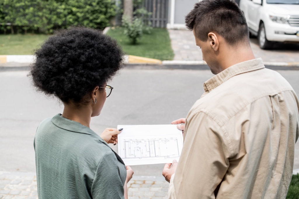 Homeowners checking paperwork for building to look for details on how old roof is