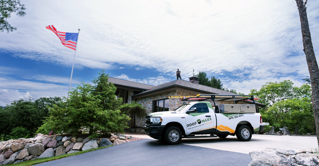 Roof Maxx professional standing on top of roof after applying treatment