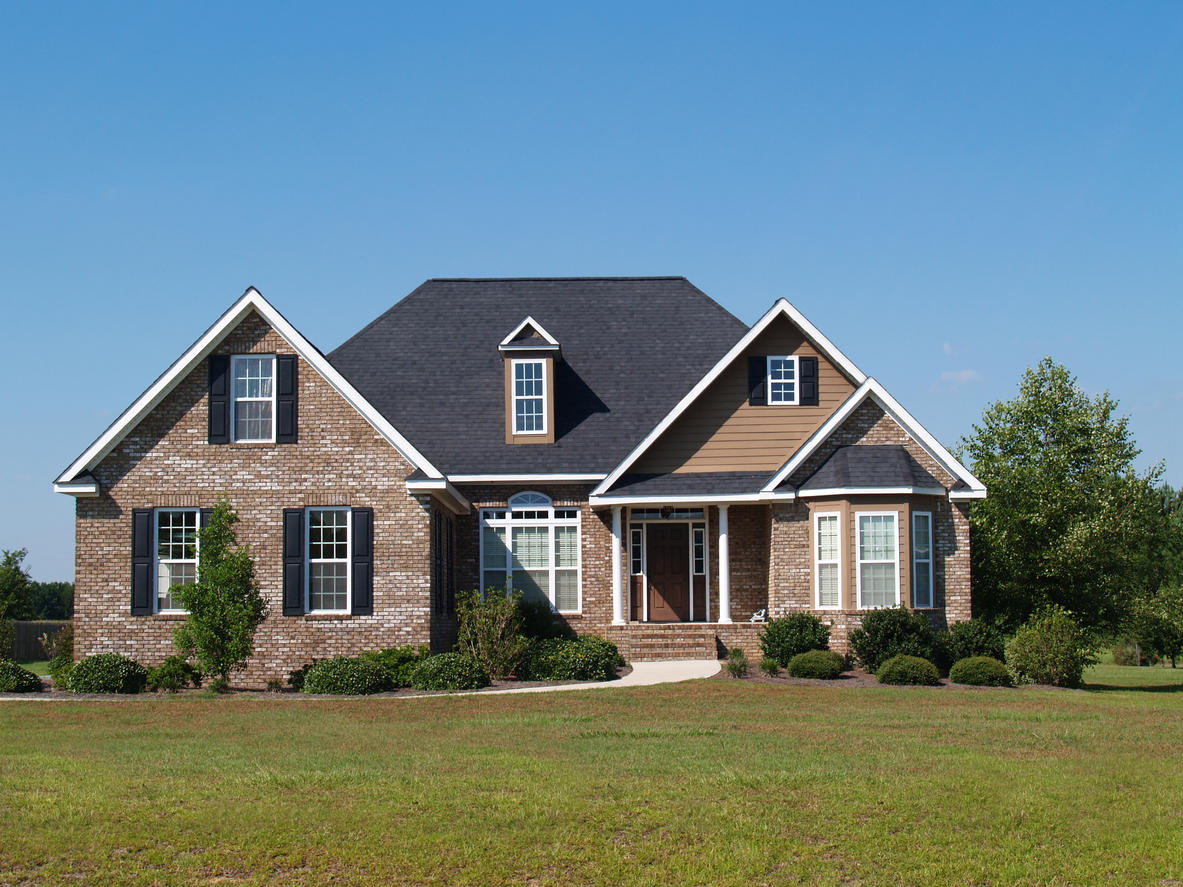A brick home with asphalt shingles