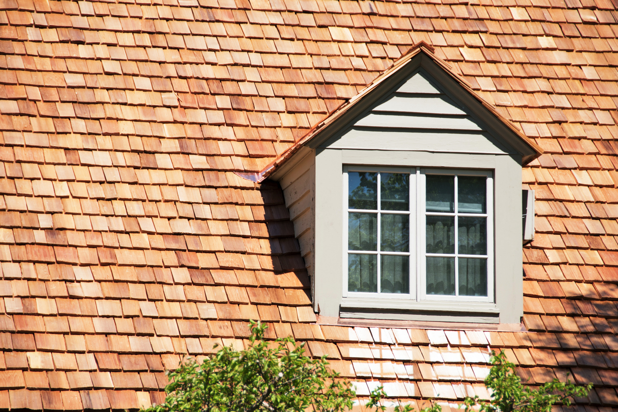 Cedar wood shingles on a house with a dormer window