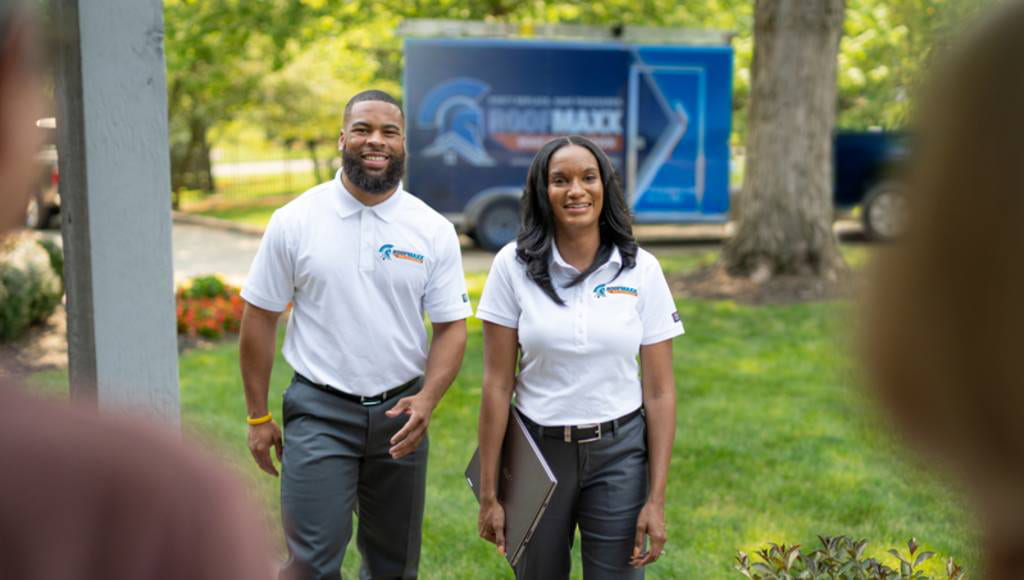 Two Roof Maxx dealers from Columbus, Ohio approach a customer's home to start a treatment.