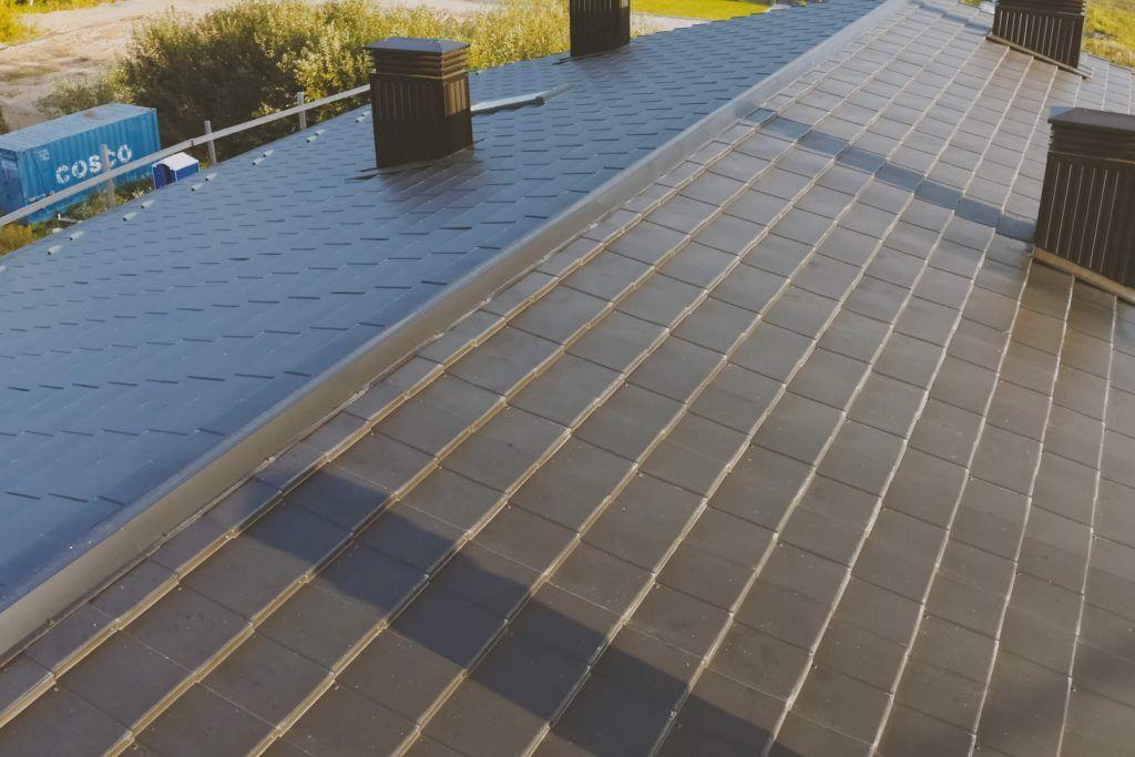 A standard gable roof with shingles and chimneys.