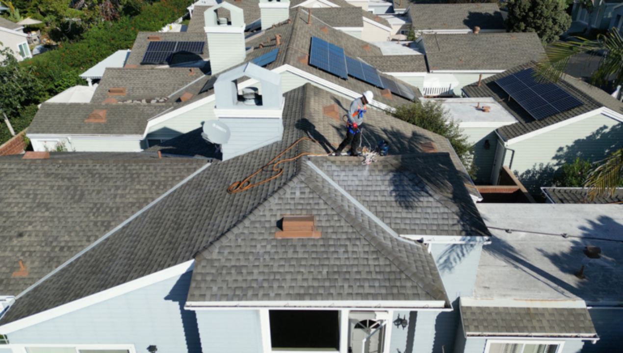 A Roof Maxx dealer sprays the treatment on a customer's home