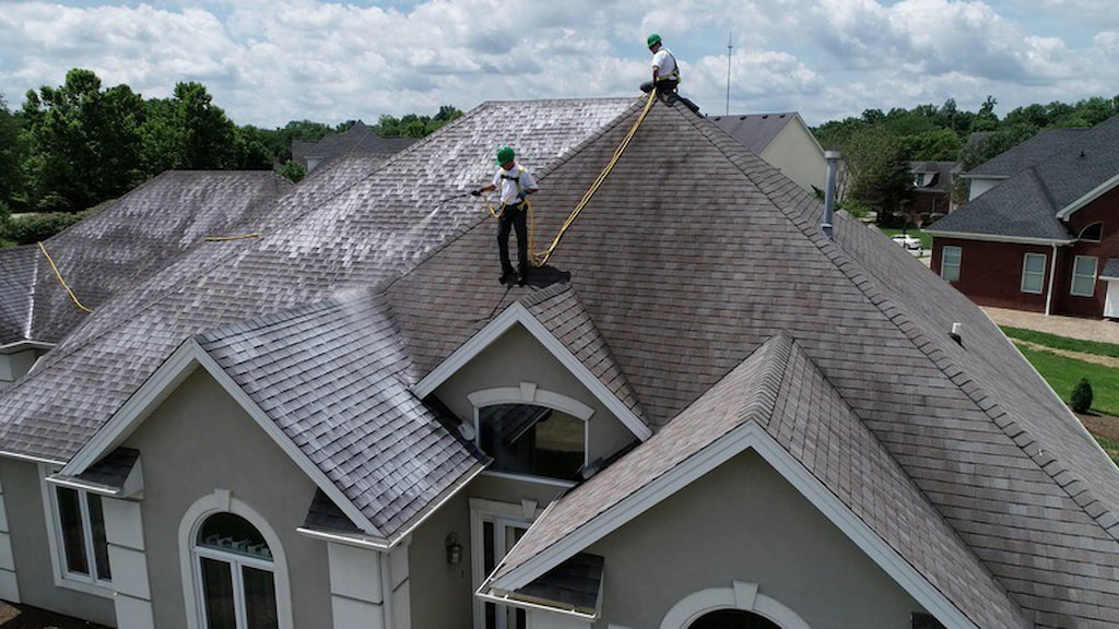 Roof Maxx professionals treating roof to extend lifespan of asphalt shingles