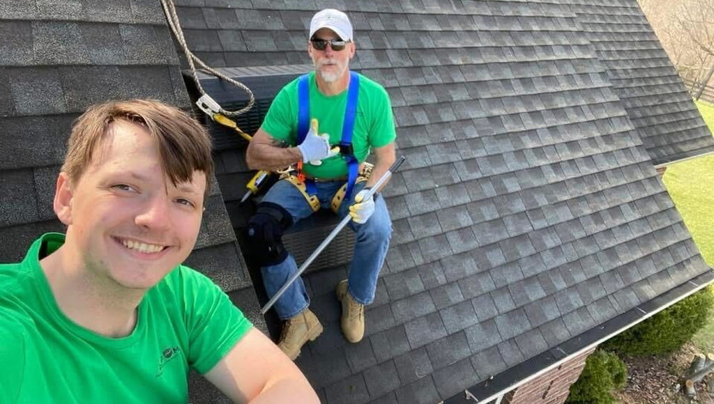 Roofers working on an asphalt shingle roof