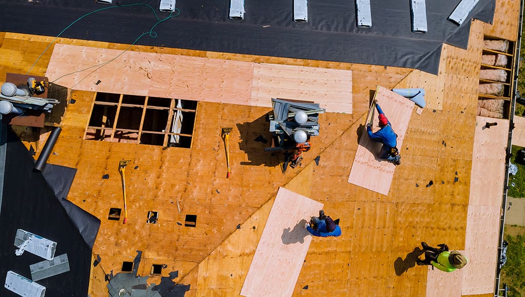 Roofers installing a new roof on a home
