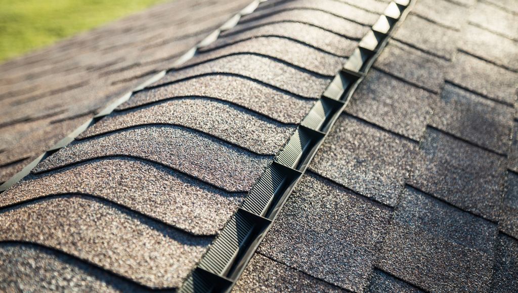 View of a roof ridge vent cap on an asphalt shingle roof