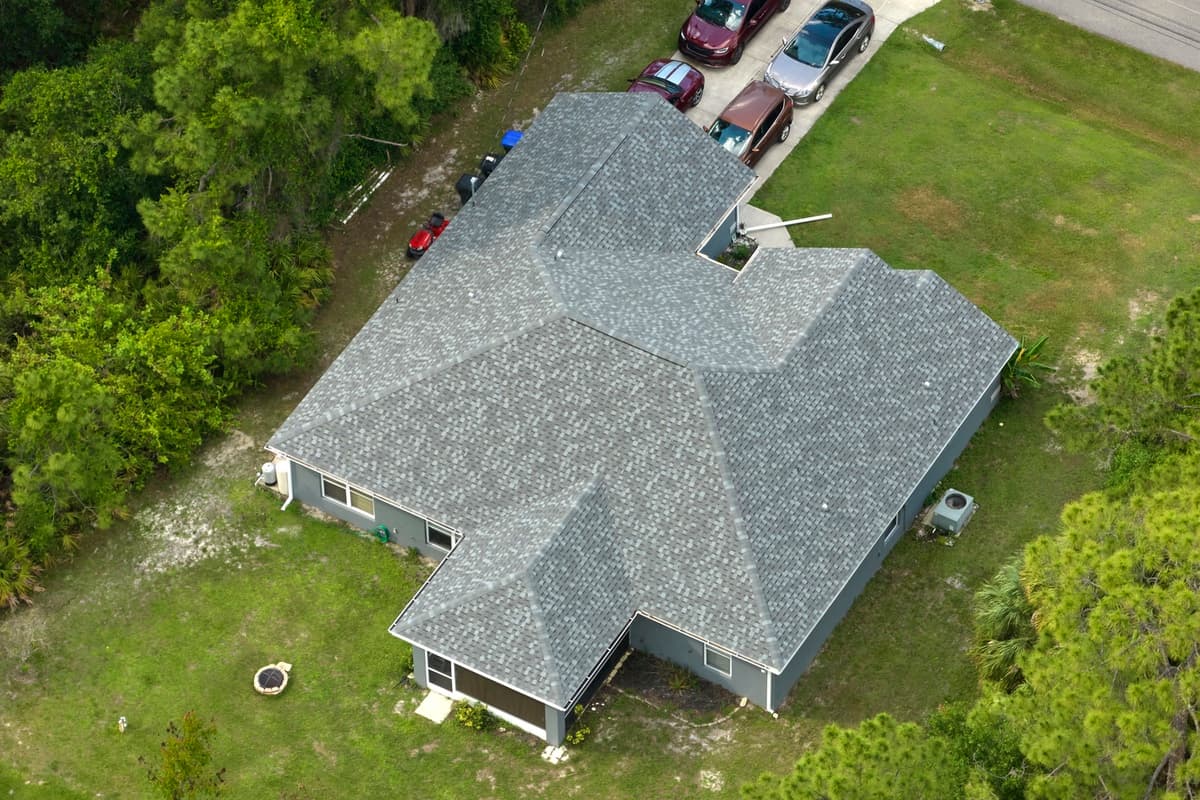 House with old shingles before roof rejuvenation process