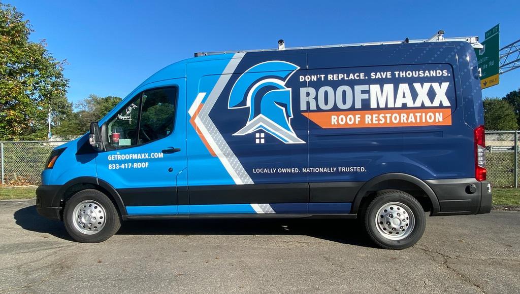 A branded van showing Roof Maxx's new, updated logo for 2025