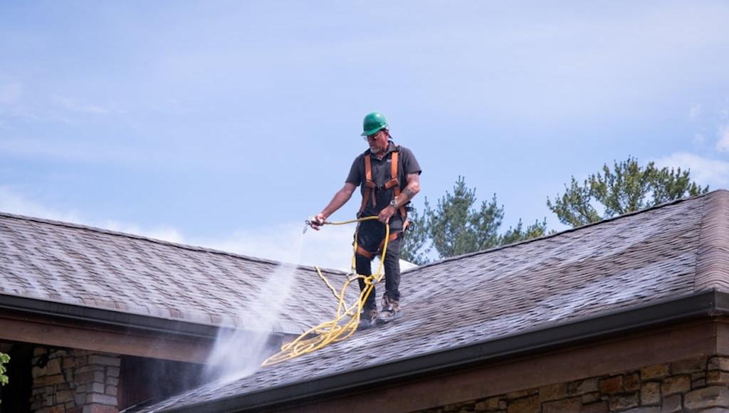 A Roof Maxx dealer sprays the treatment onto a customer's roof.