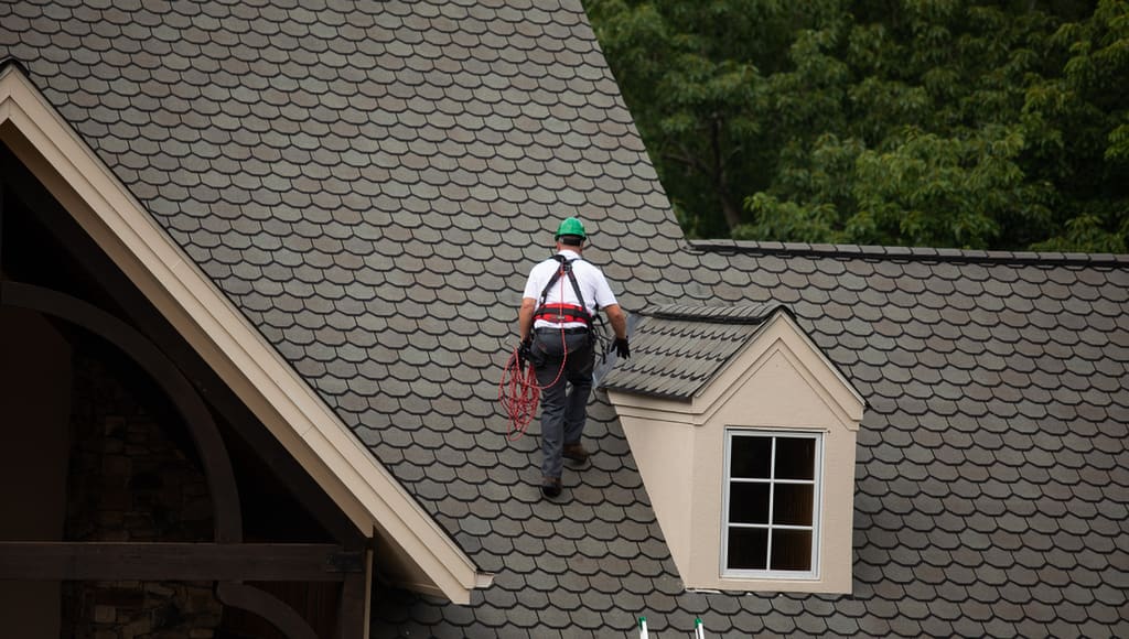A Roof Maxx dealer gets ready to treat Nascar's Austin Dillon's asphalt shingle roof.