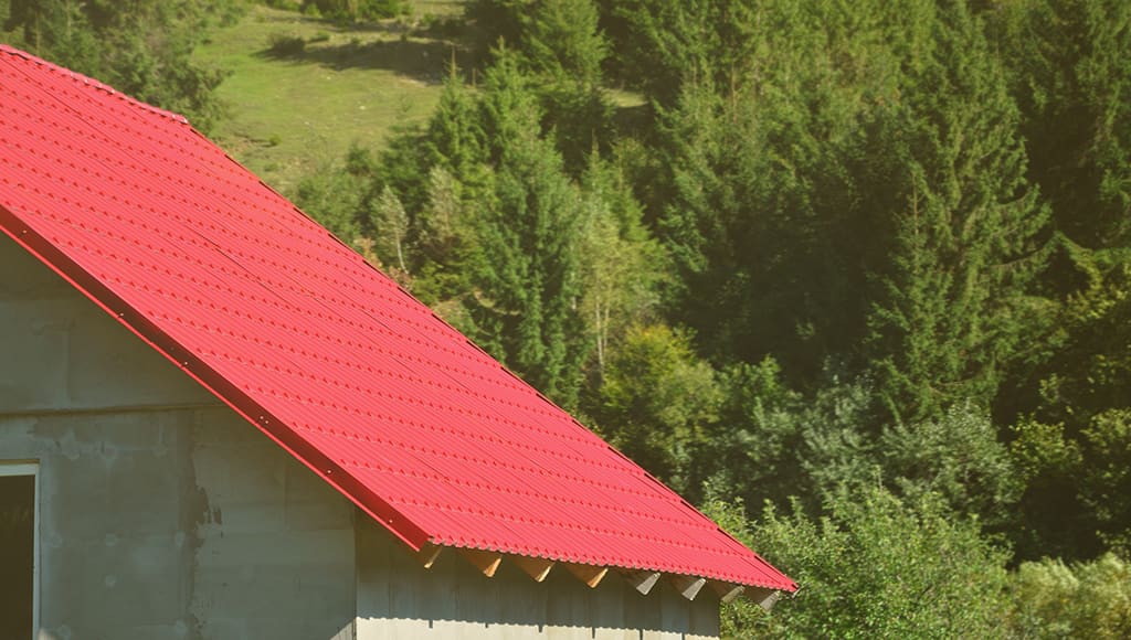 A red metal roof on a residential garage