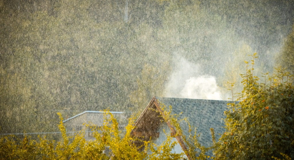 Asphalt shingle roof on US home in rainy weather