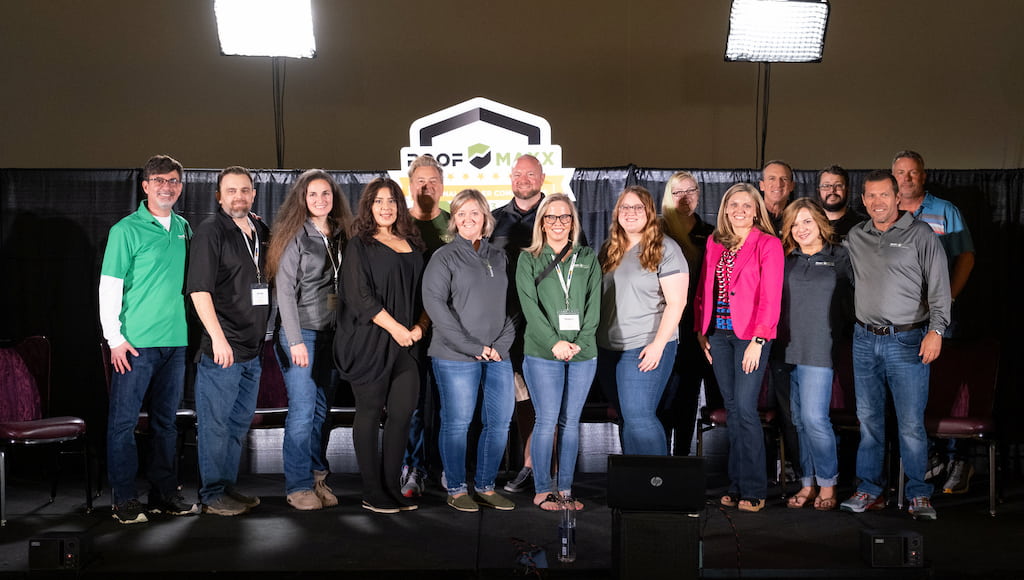 Roof Maxx dealers and employees standing together at a conference