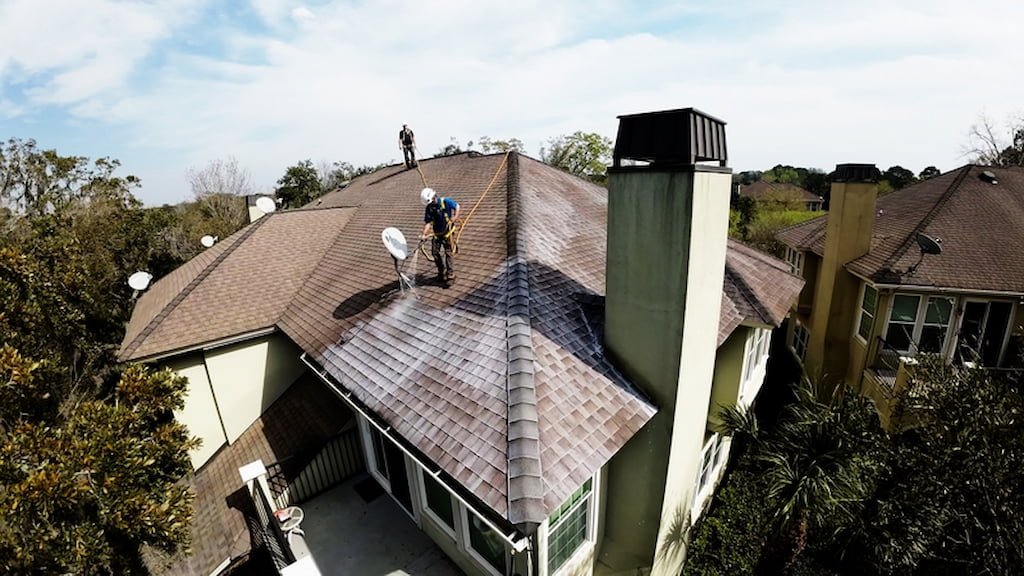 Roof Maxx contractors working to restore condition of asphalt shingle rooftop.