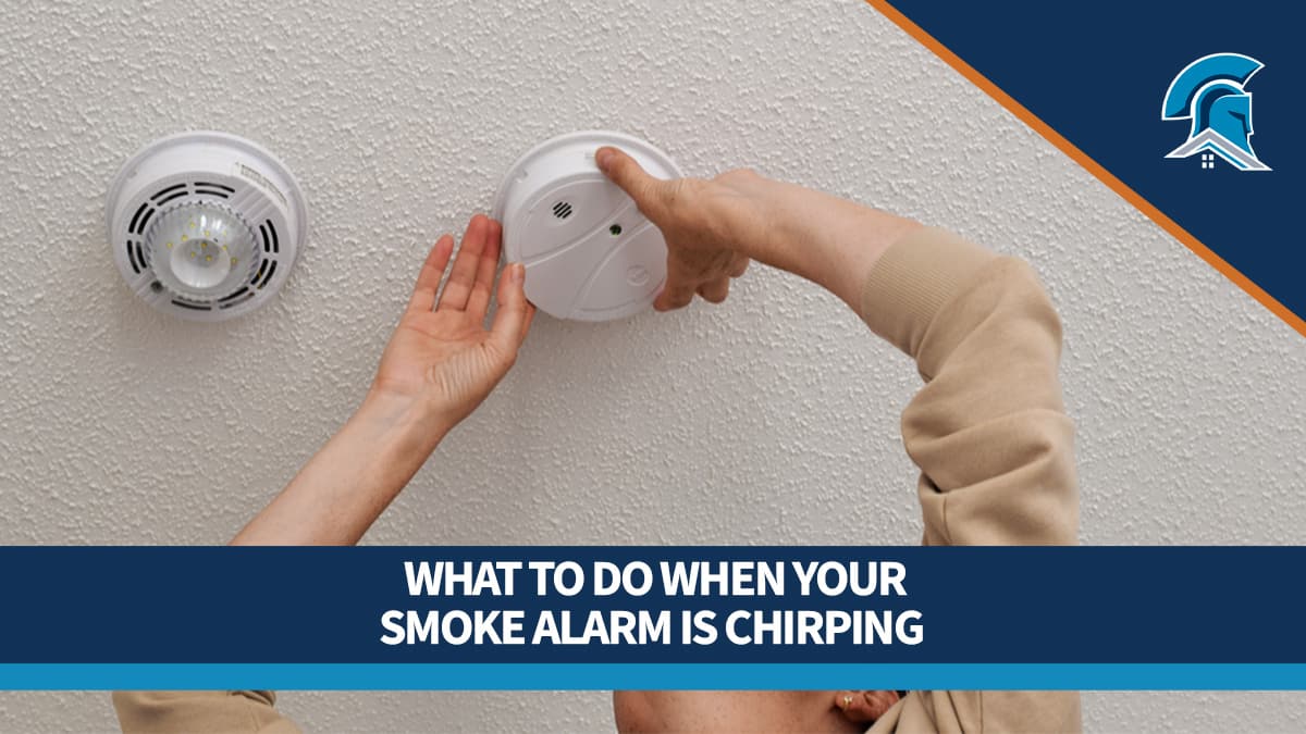 Woman changing the batteries in a smoke detector