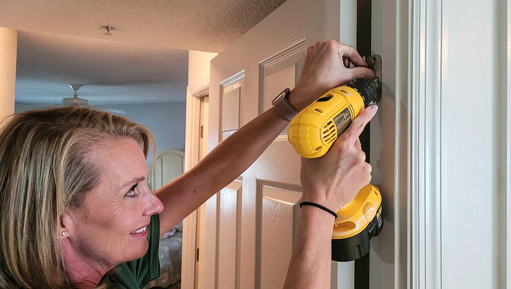 A homeowner replaces a door hinge on an interior door.