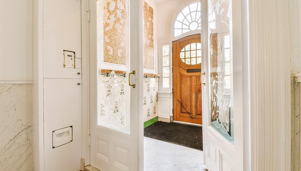 A front entryway door stuck at the halfway point.