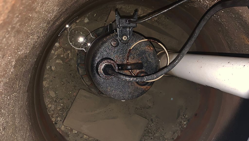 A sump pump in a basement well.