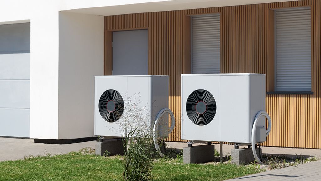 Dual heat pump HVAC systems elevated off the ground in case of a flood.
