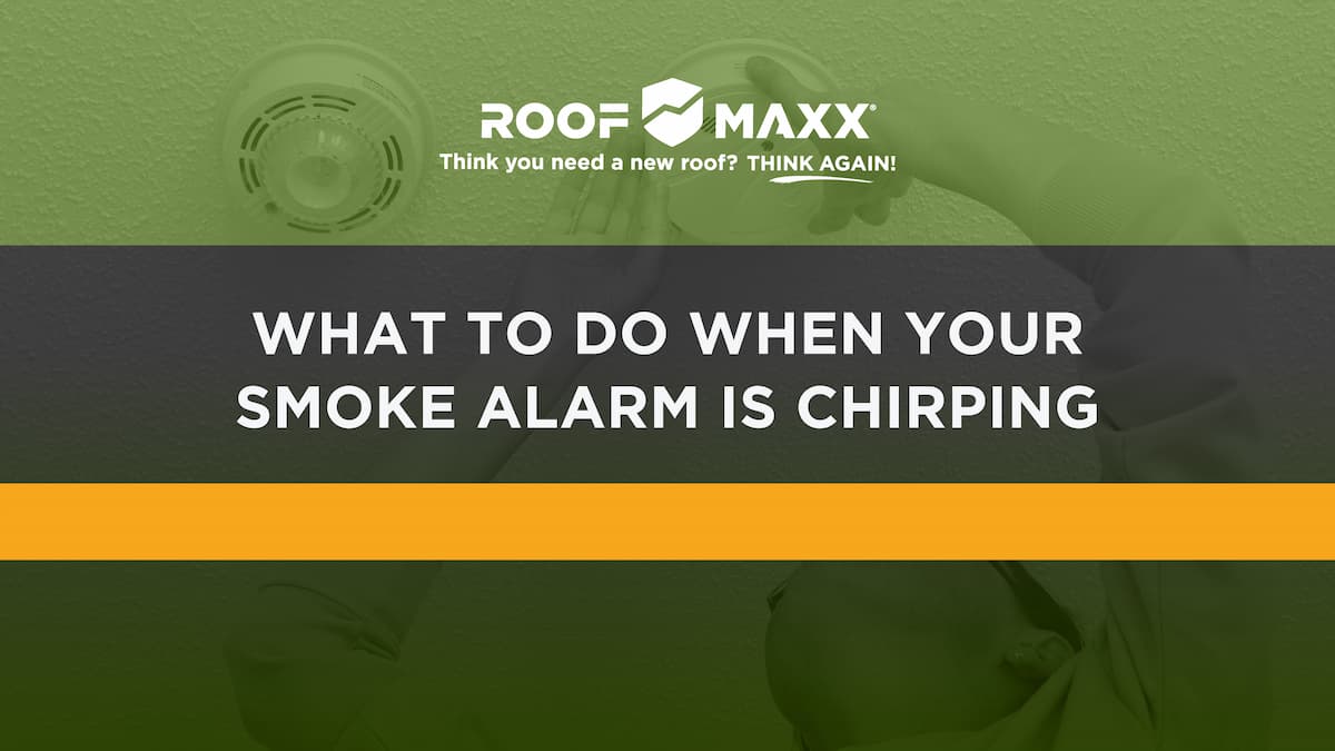 Title image with the Roof Maxx logo and title "What to Do When Your Smoke Alarm Is Chirping" on a green transparency over an image of a woman checking her smoke detector.