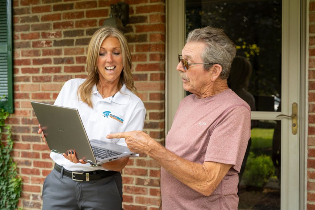 Roof Maxx dealer shows customer their roof score