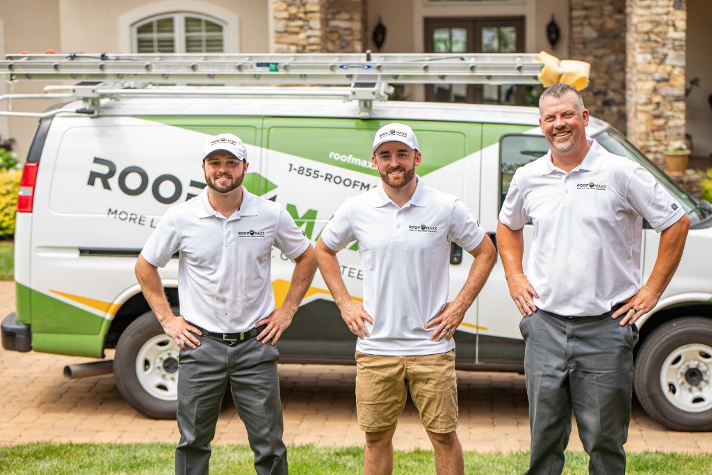 Nascar's Austin Dillon gives an endorsement with two Roof Maxx dealers in front of a customer's home.