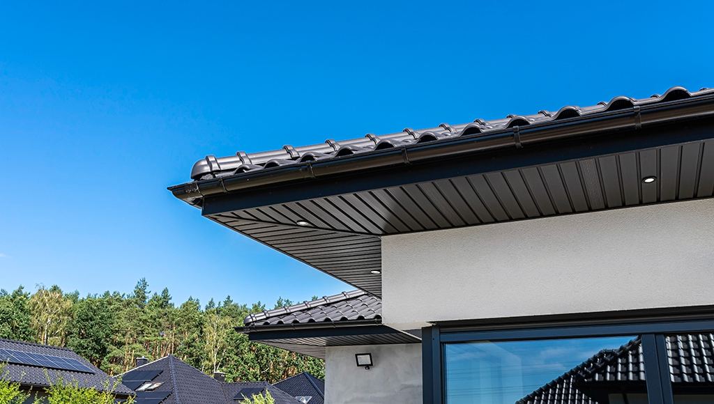 A modern contemporary home with a black metal gutter.