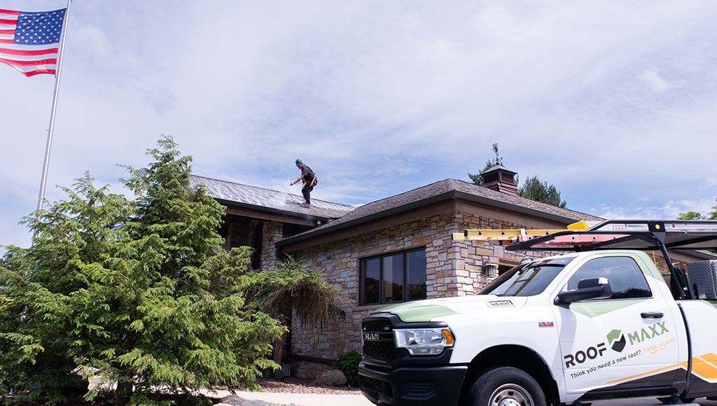 A Roof Maxx dealer sprays the treatment on a customer's roof.