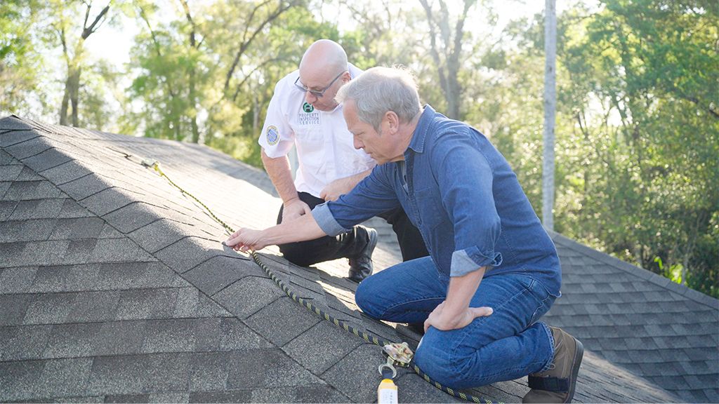 Mike Rowe and James Gonte examine rooftop on Florida home before Roof Maxx treatment