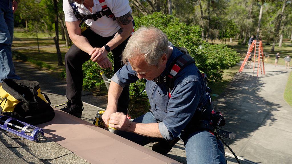 Mike Rowe securing roof vent with screw and sealant