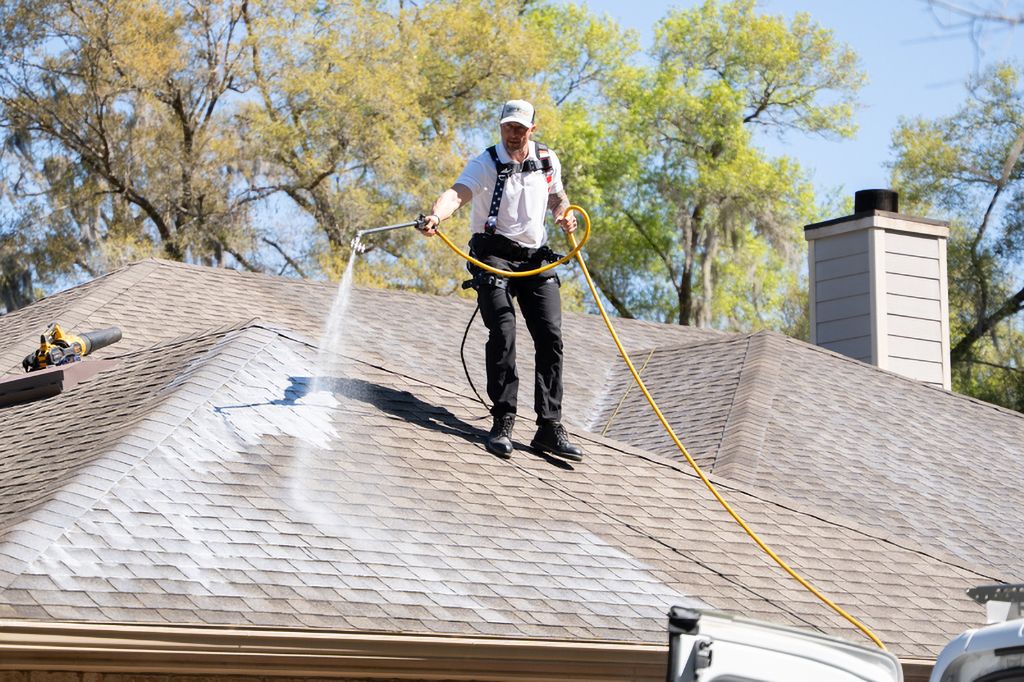 A Roof Maxx dealers sprays our soy-based treatment onto a customer's roof