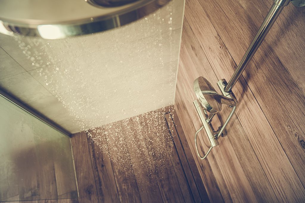 A low-flow rainfall shower head in the bathroom of a home