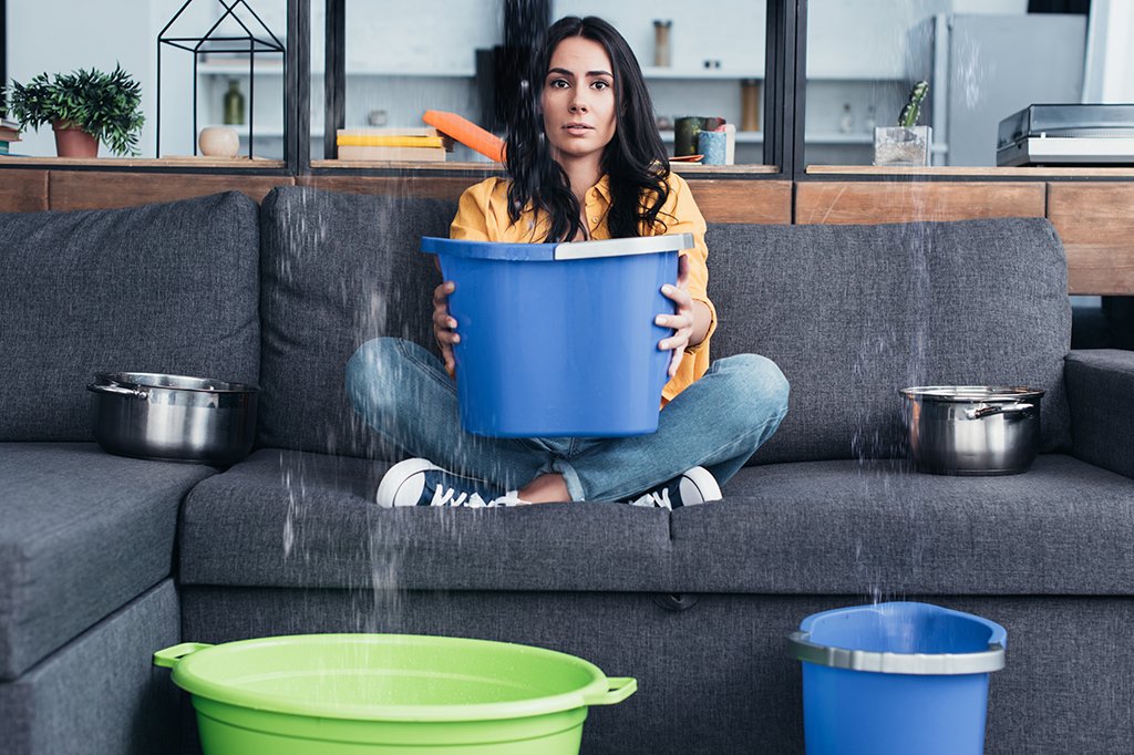 A woman uses what she has on hand to catch leaks in her living room!