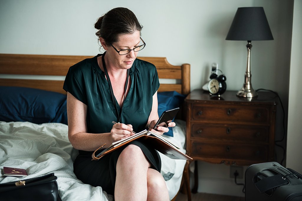 A woman documents photos, videos, and dates for her home insurance claim.