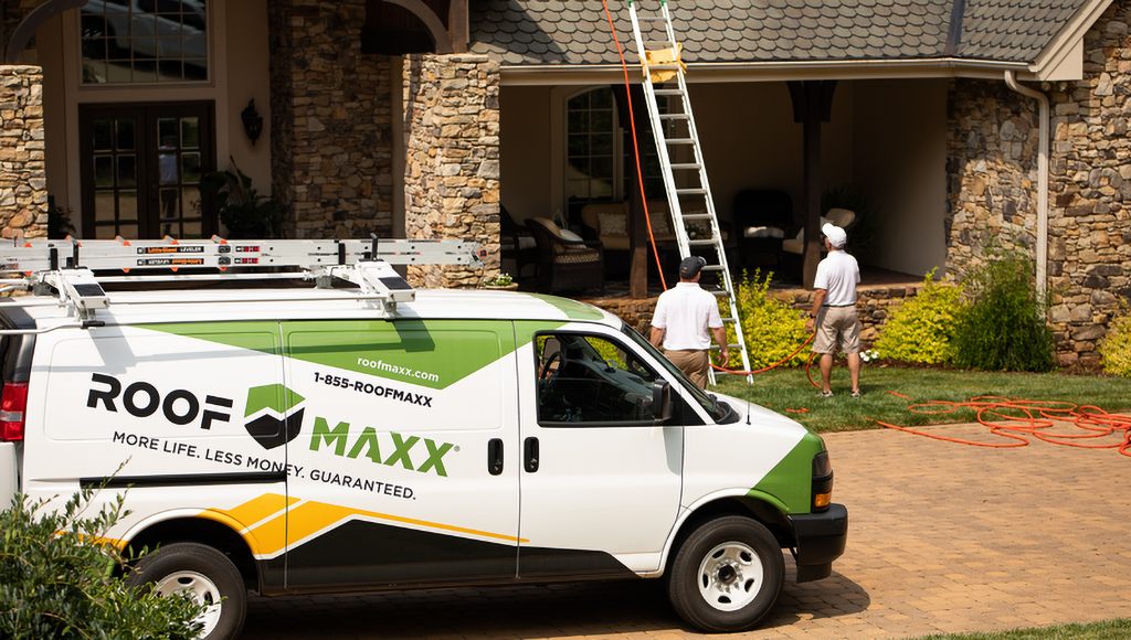 A Roof Maxx van parked in front a customer's home.