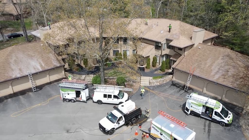 Condos with asphalt shingle rooftops during Roof Maxx treatment to reflect considerations in building design