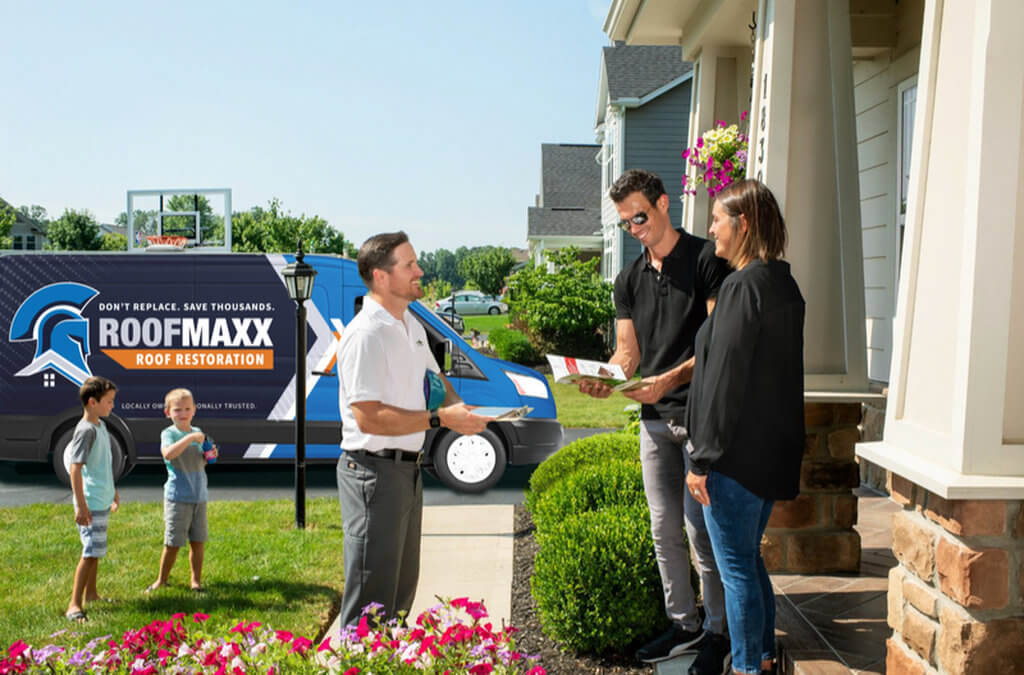 A Roof Maxx dealer explains the Roof Maxx treatment process to homeowners.