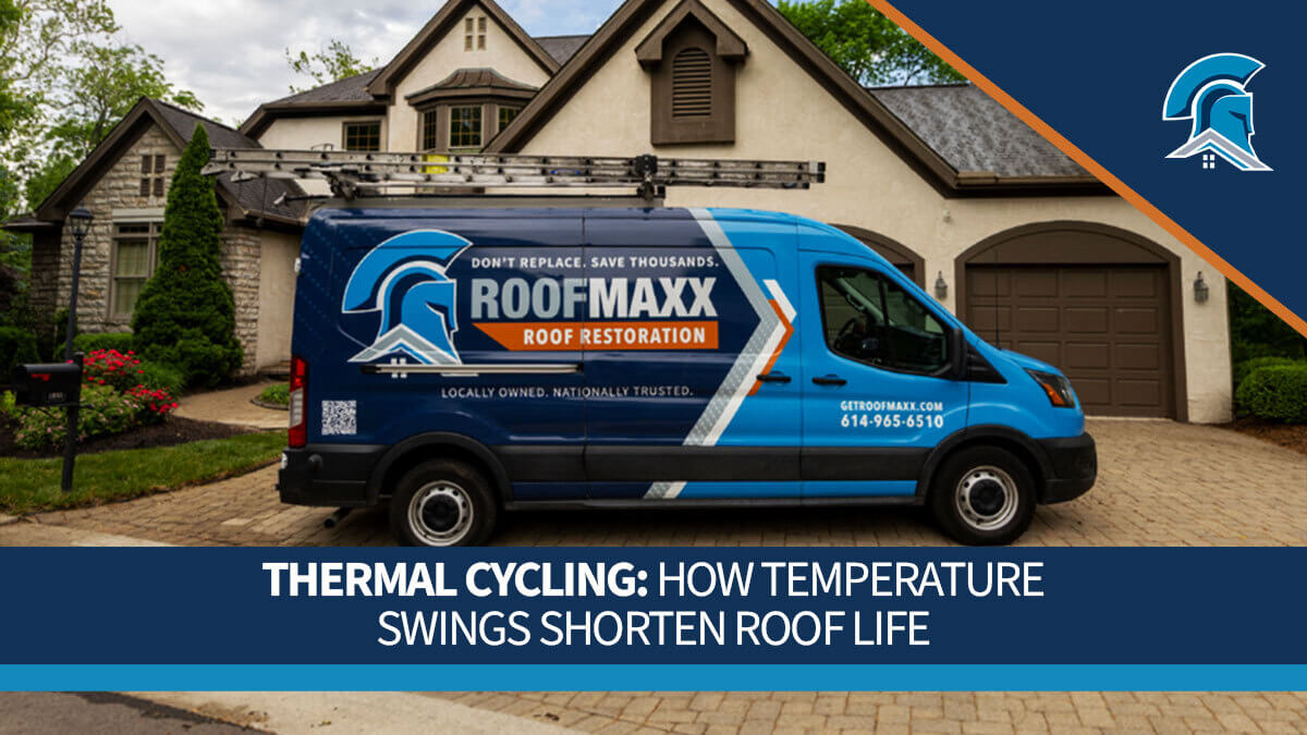 A blue Roof Maxx service van parked in front of a house on a partially cloudy day.