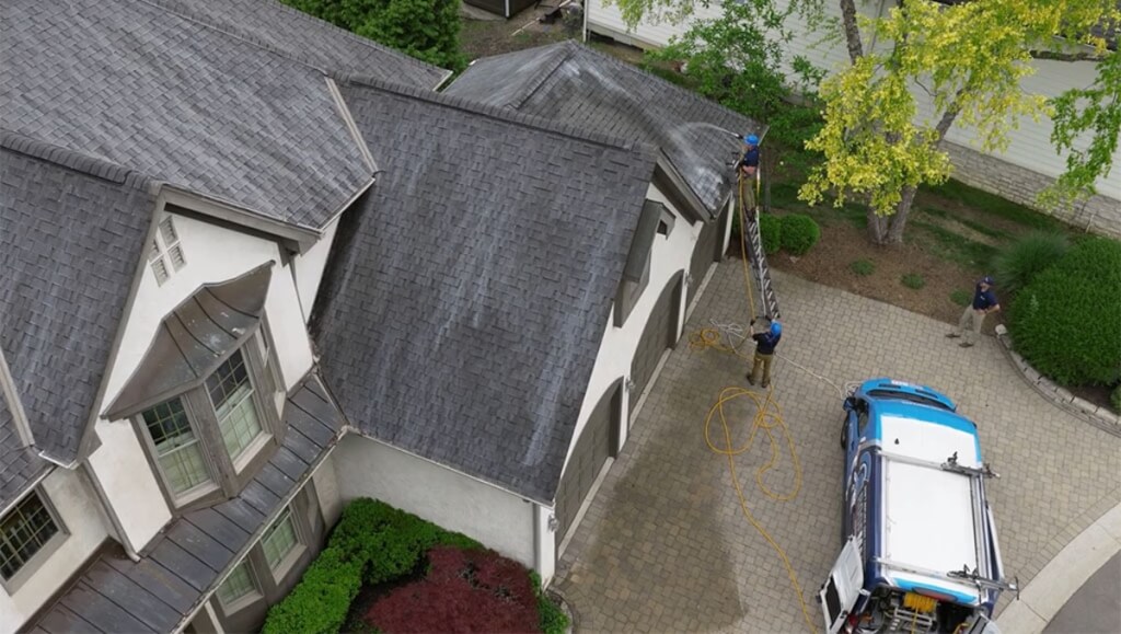 O'Shay Mallory treating the roof on a customer's house in Columbus, Ohio.