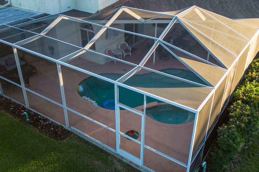 Aerial photo of a mosquito net screen with a hard-sided metal frame around a pool