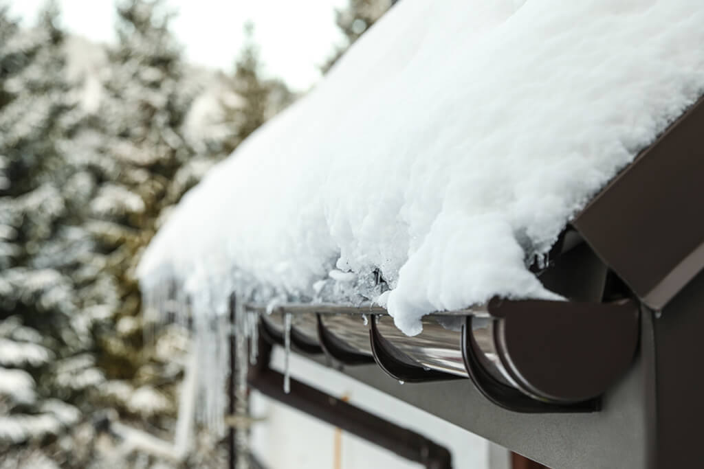 An example of an ice dam at the roof line and gutters on a residential home.