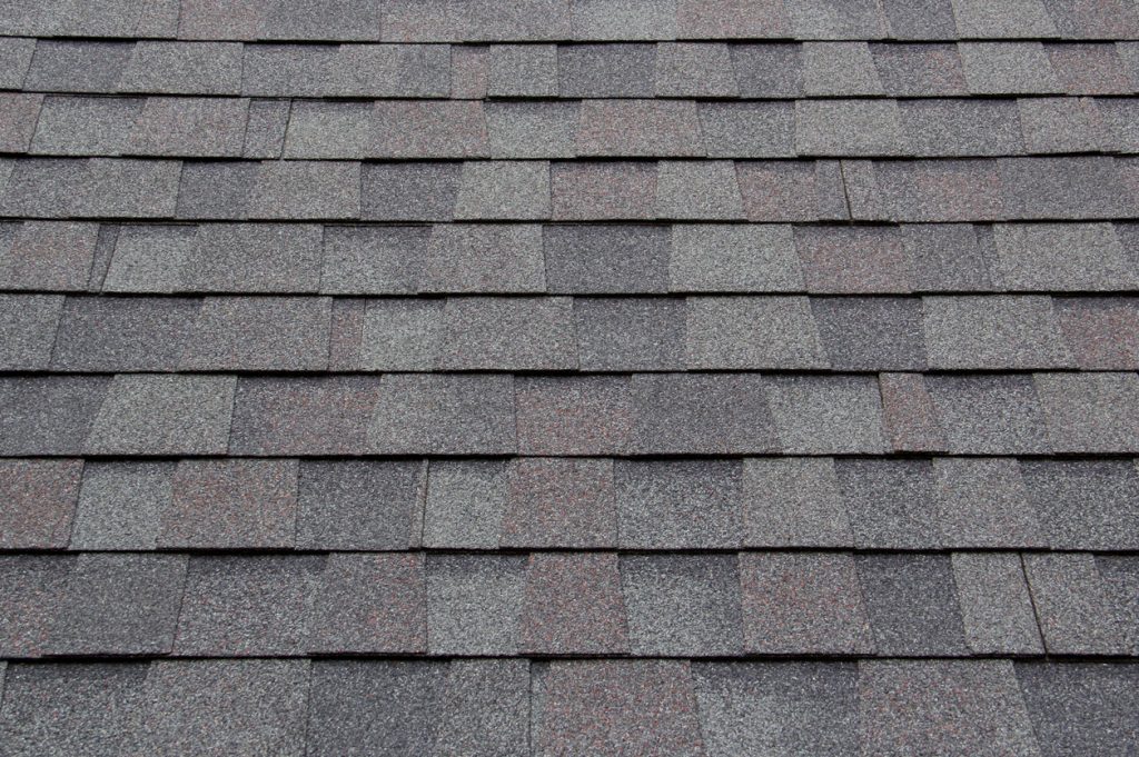 Asphalt shingles properly laid out on roof.